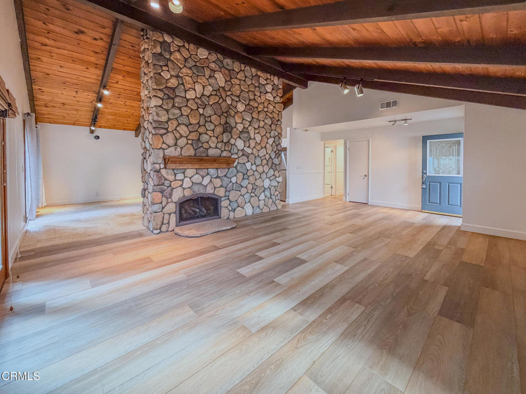 5142 Sandpiper Way Oxnard, CA 93035 - Photo 20 of 51 a view of empty room with fireplace and wooden floor