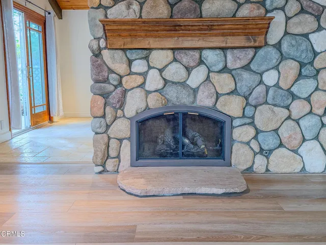a big room with wooden floor and windows