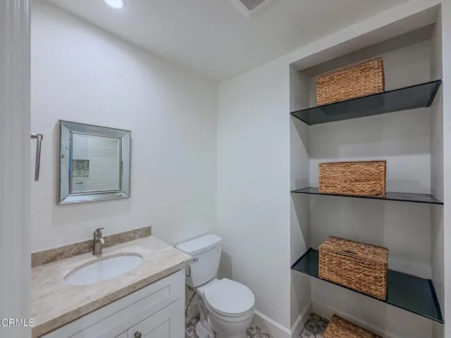 a spacious bathroom with a double vanity sink and a mirror
