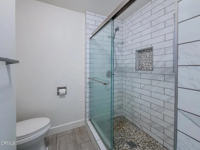 a spacious bathroom with a double vanity sink a mirror and a shower