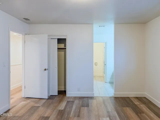 a view of an empty room with wooden floor