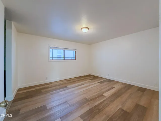 a view of room with wooden floor and fan