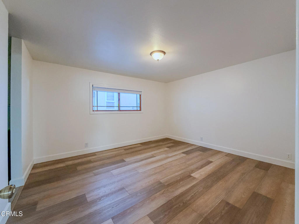 5142 Sandpiper Way Oxnard, CA 93035 - Photo 33 of 51 a view of an empty room with wooden floor and a window