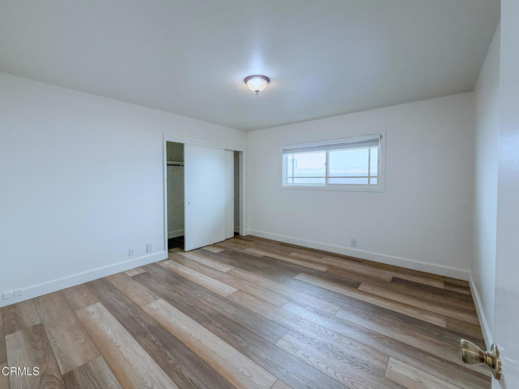 5142 Sandpiper Way Oxnard, CA 93035 - Photo 42 of 51 a view of an empty room with wooden floor and a window
