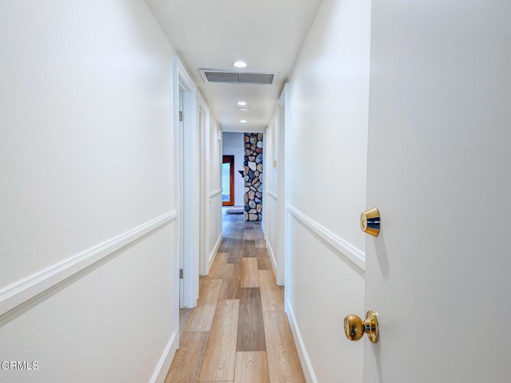 5142 Sandpiper Way Oxnard, CA 93035 - Photo 43 of 51 a view of a hallway with wooden floor and staircase