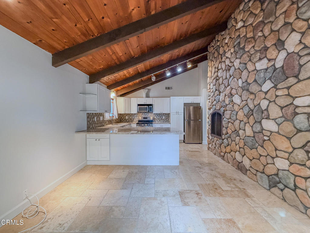 5142 Sandpiper Way Oxnard, CA 93035 - Photo 7 of 51 a large white kitchen with a sink and cabinets