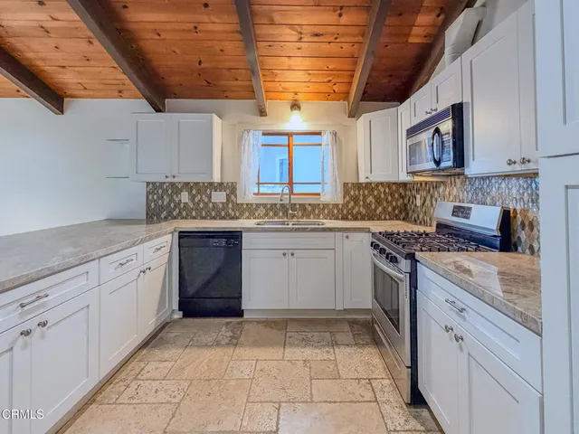 a kitchen with a sink stove and cabinets