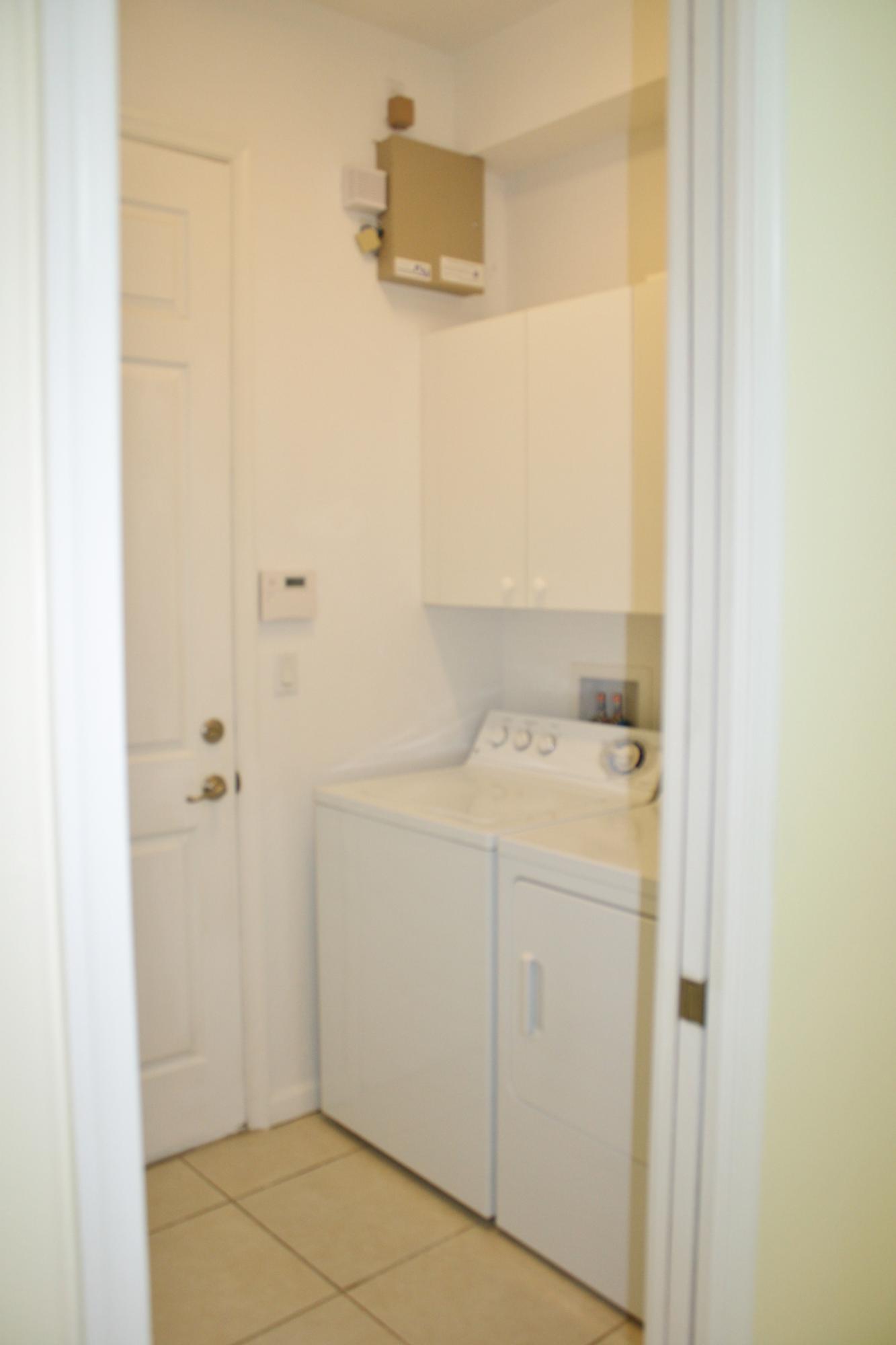 334 Southwest Walking Path, Unit 334 Stuart, FL 34997 - Photo 14 of 34 a utility room with dryer and washer