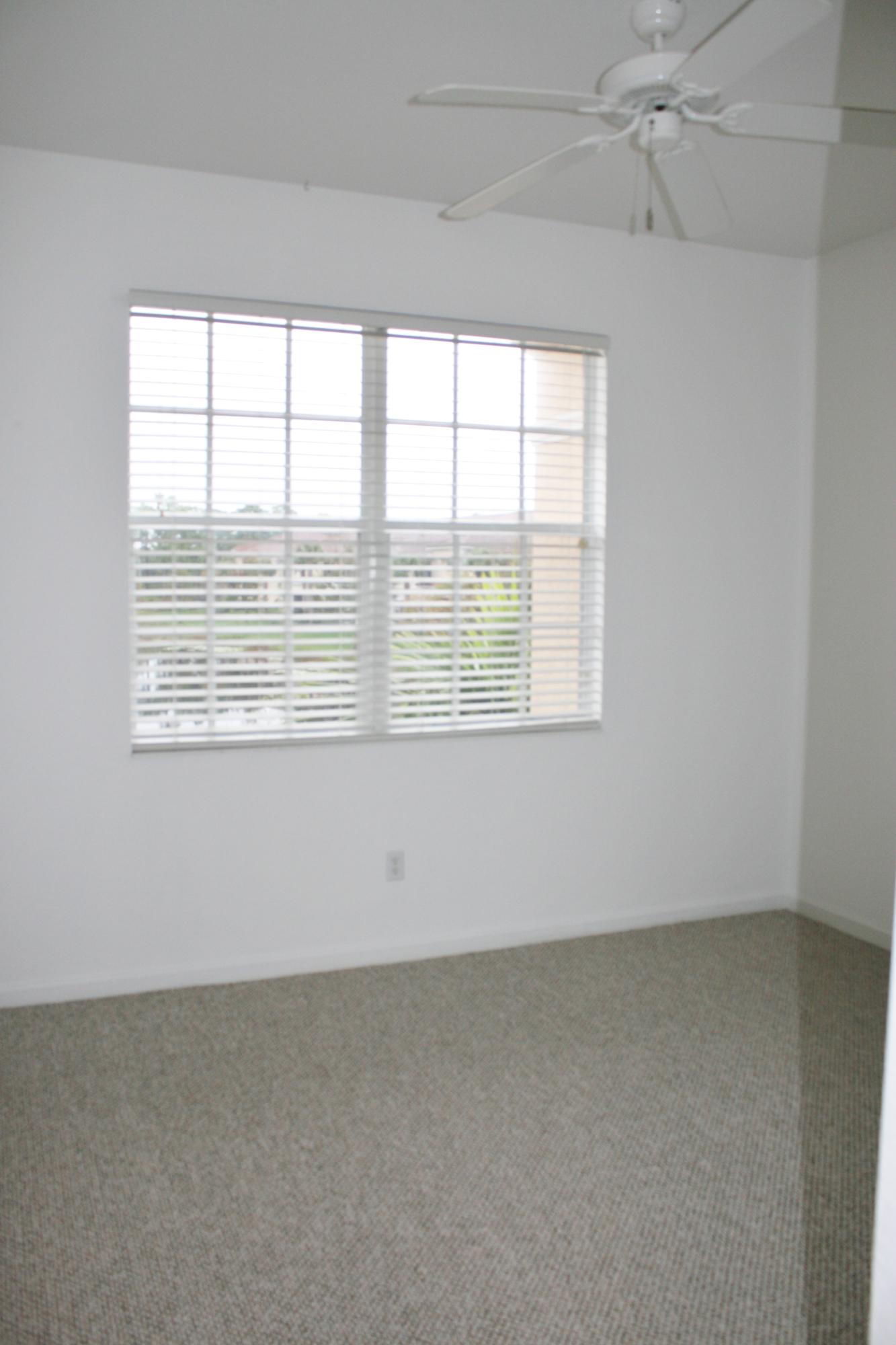334 Southwest Walking Path, Unit 334 Stuart, FL 34997 - Photo 23 of 34 an empty room with a window