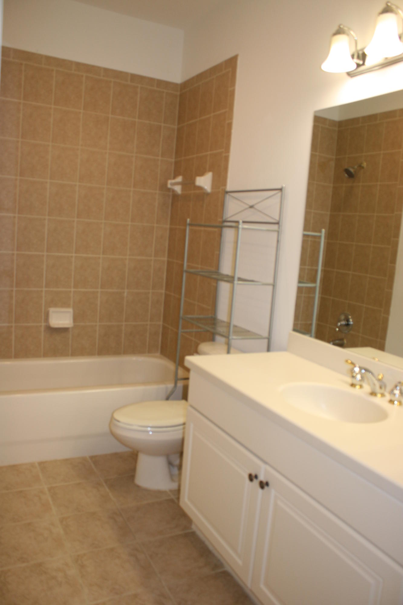 334 Southwest Walking Path, Unit 334 Stuart, FL 34997 - Photo 25 of 34 a bathroom with a sink a toilet and shower
