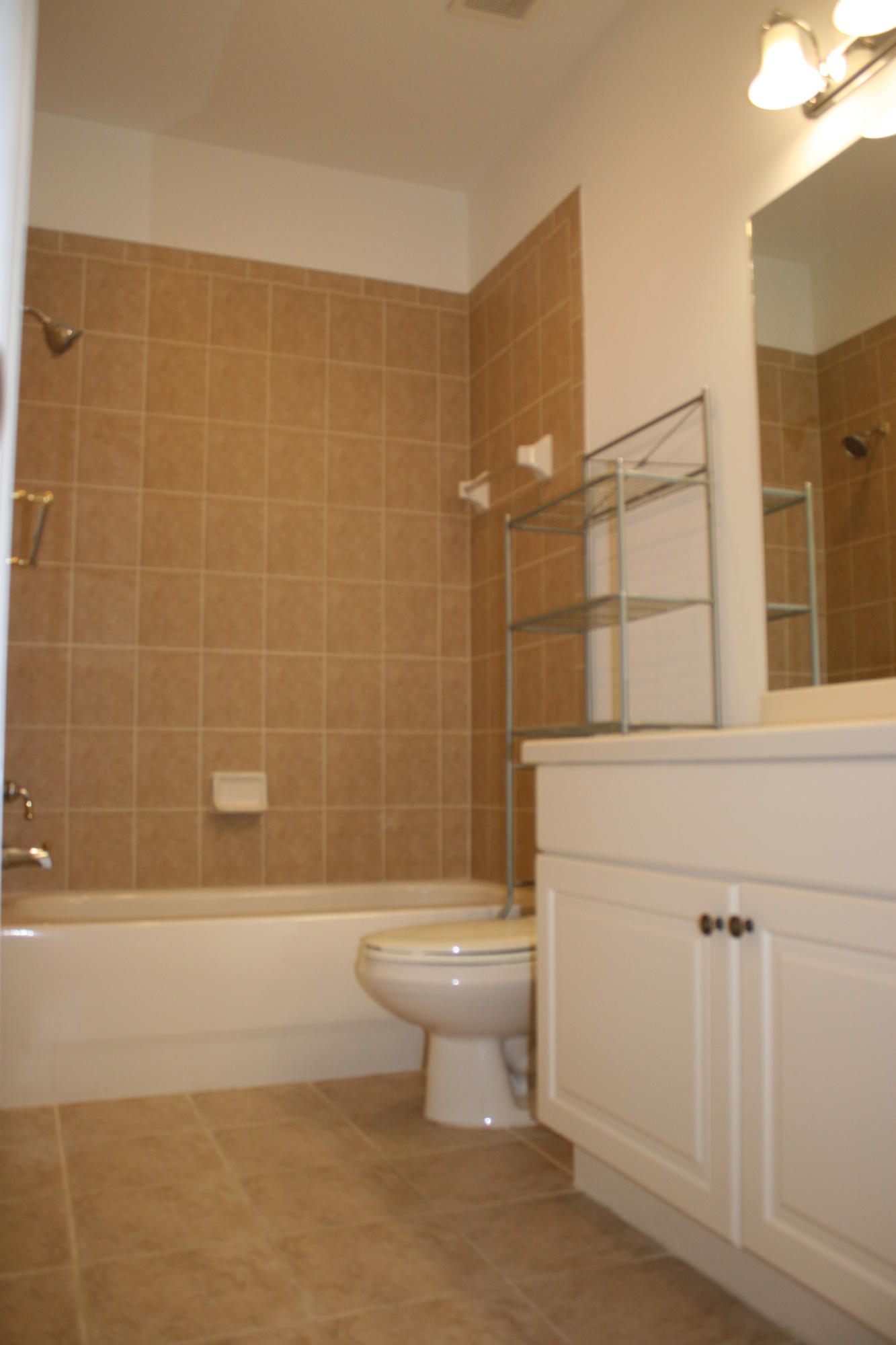 334 Southwest Walking Path, Unit 334 Stuart, FL 34997 - Photo 26 of 34 a bathroom with a toilet and a shower