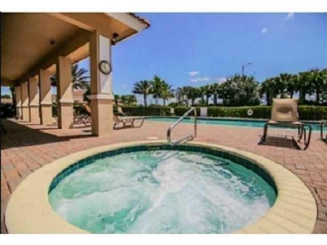 334 Southwest Walking Path, Unit 334 Stuart, FL 34997 - Photo 29 of 34 a view of a swimming pool with a yard