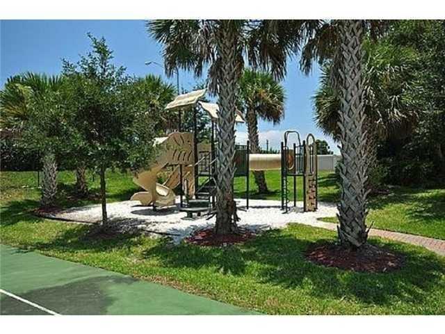 334 Southwest Walking Path, Unit 334 Stuart, FL 34997 - Photo 33 of 34 a view of a park with a tree