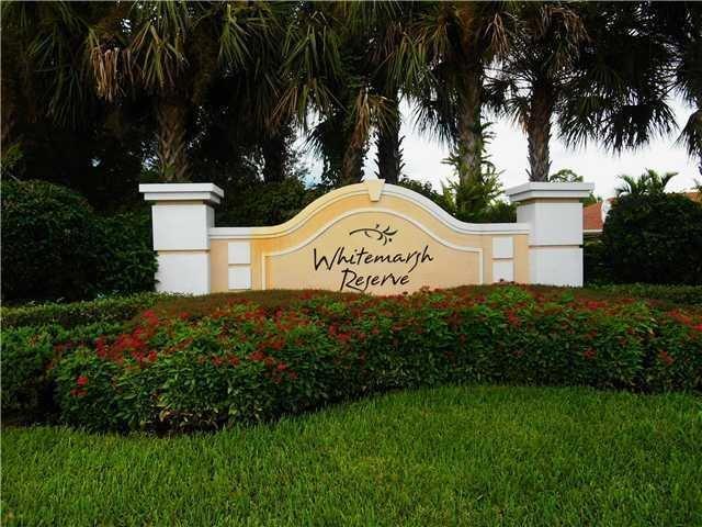 334 Southwest Walking Path, Unit 334 Stuart, FL 34997 - Photo 34 of 34 a sign of golf club on a wall under a tree