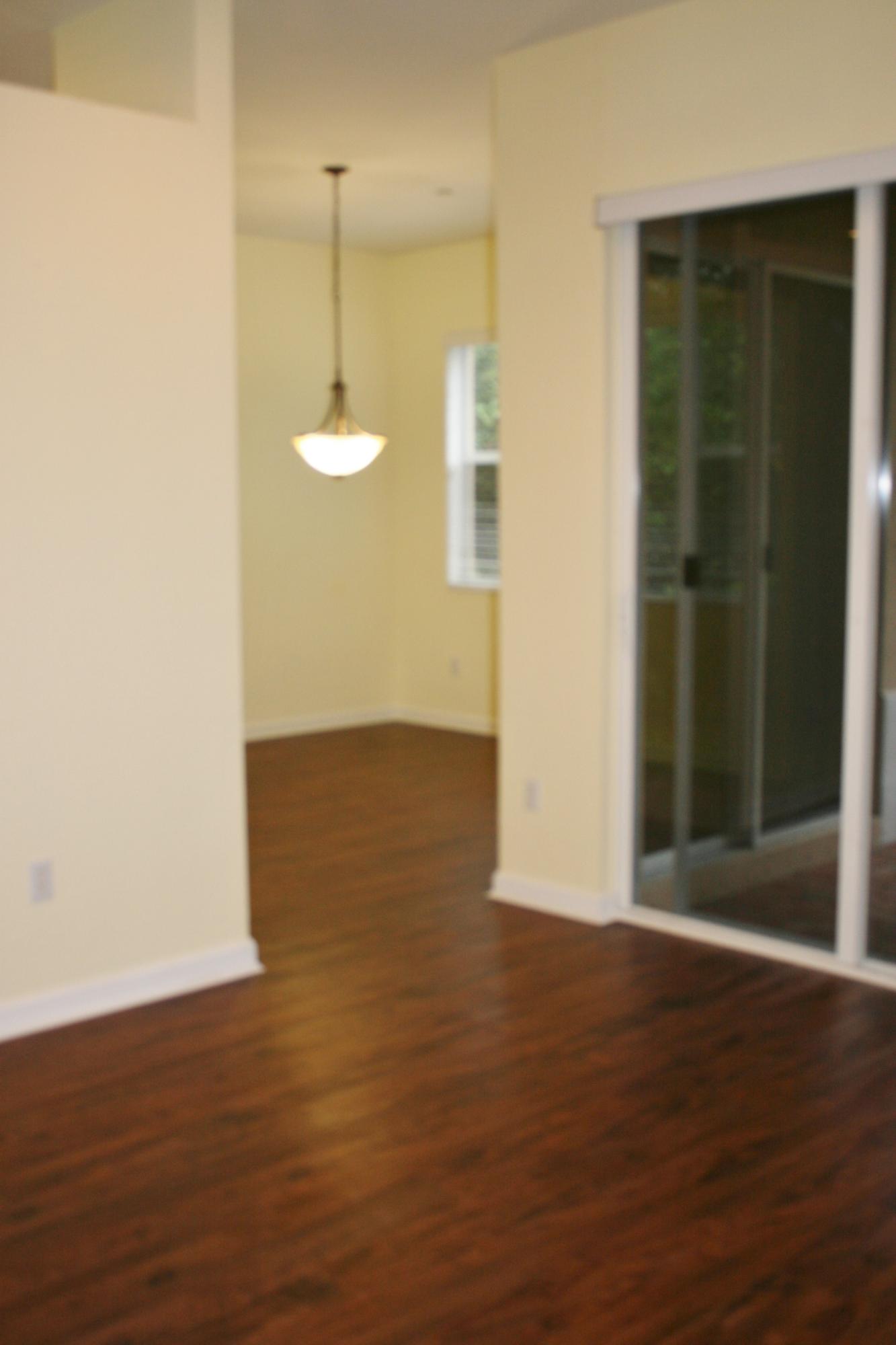 334 Southwest Walking Path, Unit 334 Stuart, FL 34997 - Photo 6 of 34 an empty room with wooden floor and windows