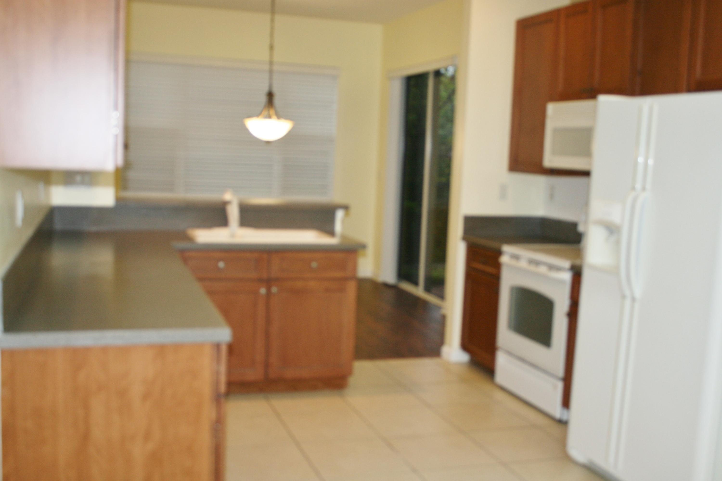 334 Southwest Walking Path, Unit 334 Stuart, FL 34997 - Photo 8 of 34 a kitchen with a sink a stove and washer
