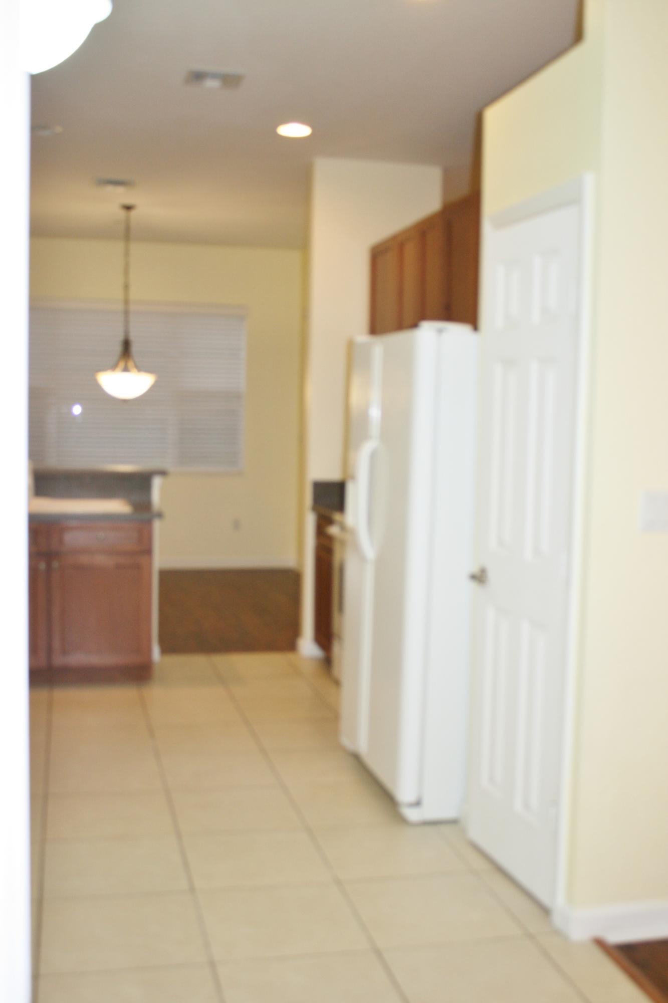 334 Southwest Walking Path, Unit 334 Stuart, FL 34997 - Photo 9 of 34 a view of a kitchen with a refrigerator and a sink