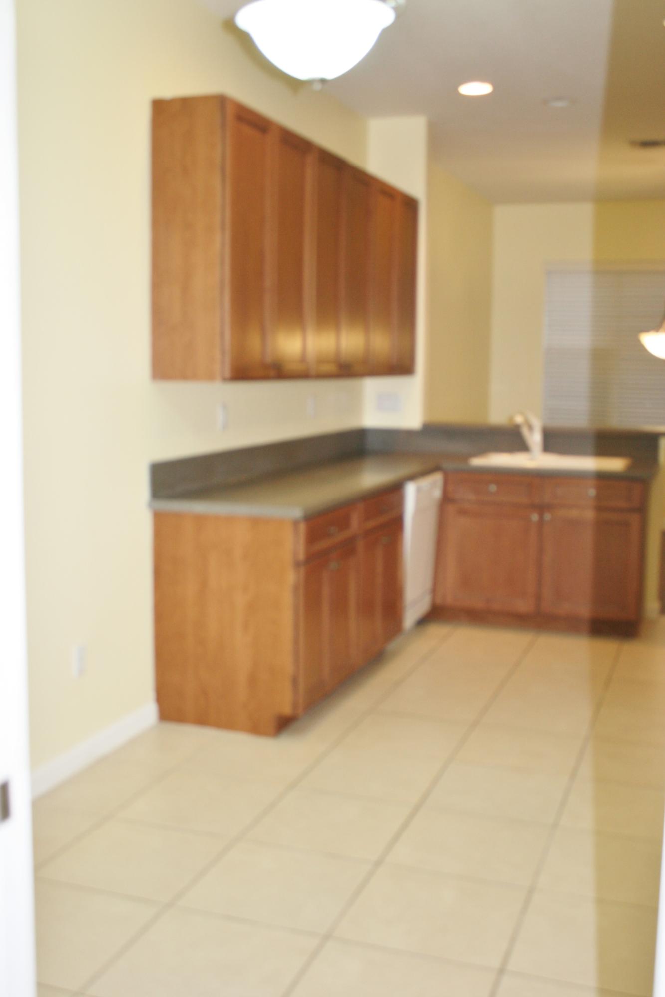 334 Southwest Walking Path, Unit 334 Stuart, FL 34997 - Photo 10 of 34 a kitchen with stainless steel appliances a cabinets and wooden floor