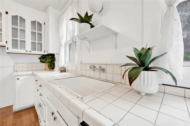 a kitchen with a stove a refrigerator and a dining table