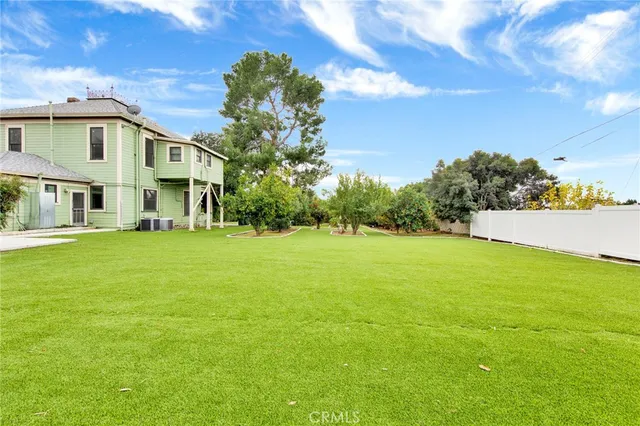 an aerial view of a house with a yard swimming pool outdoor seating