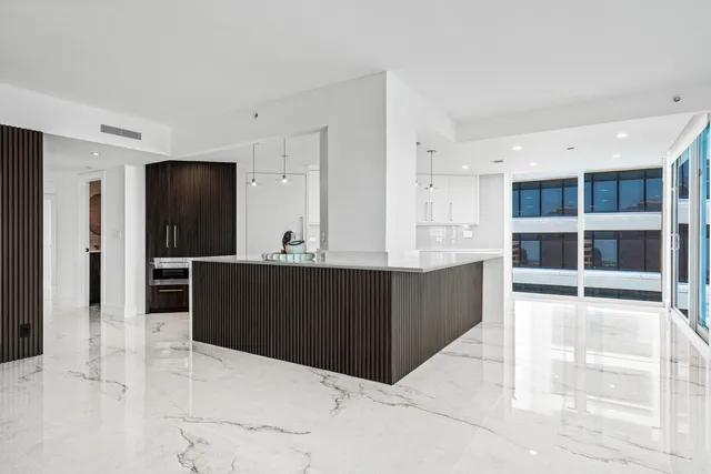 a view of cabinets with wooden floor and kitchen view