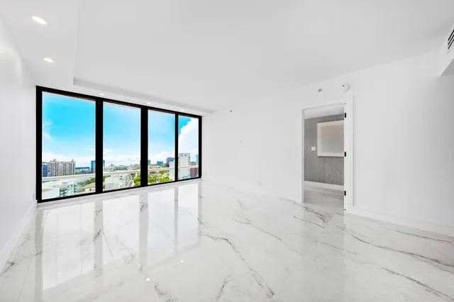 an empty room with large windows