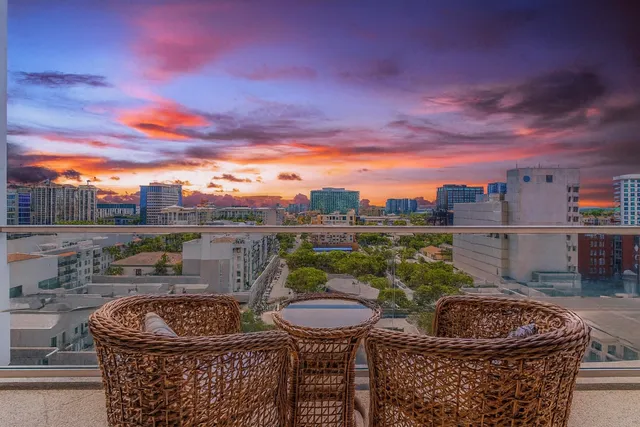 a balcony with furniture and a potted plant