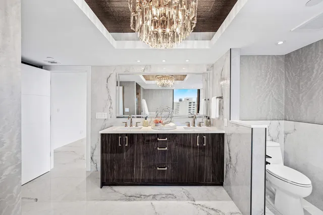 a bathroom with a sink vanity granite and toilet
