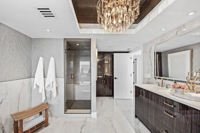 a bathroom with a double vanity sink a large mirror and a shower