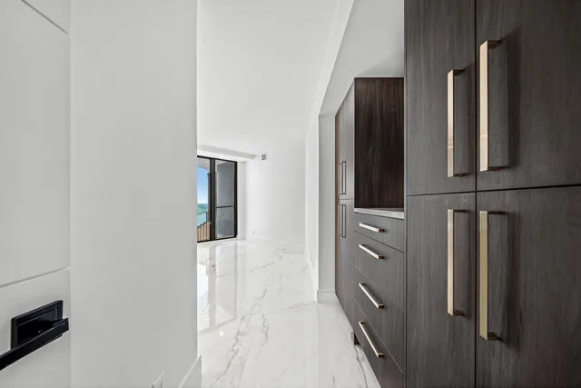 a kitchen with stainless steel appliances kitchen island granite countertop a refrigerator and a stove