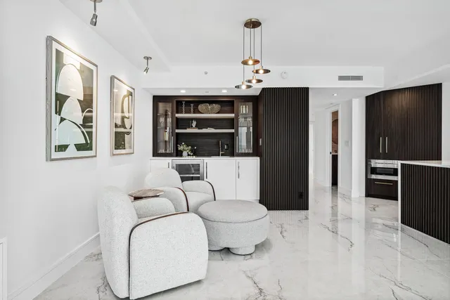 a view of kitchen with kitchen island granite countertop a refrigerator and cabinets