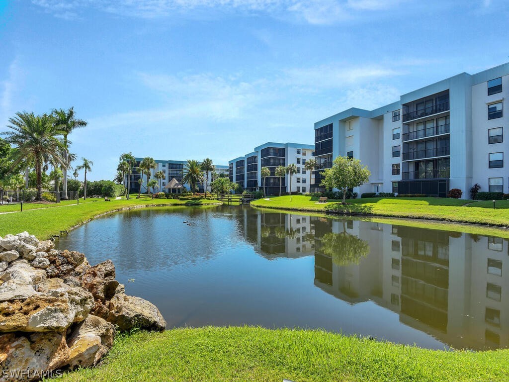 a view of a lake with a building and outdoor space