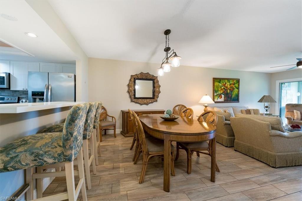 75 St Andrews Boulevard, Unit C301 Naples, FL 34113 - Photo 11 of 41 a view of a dining room with furniture