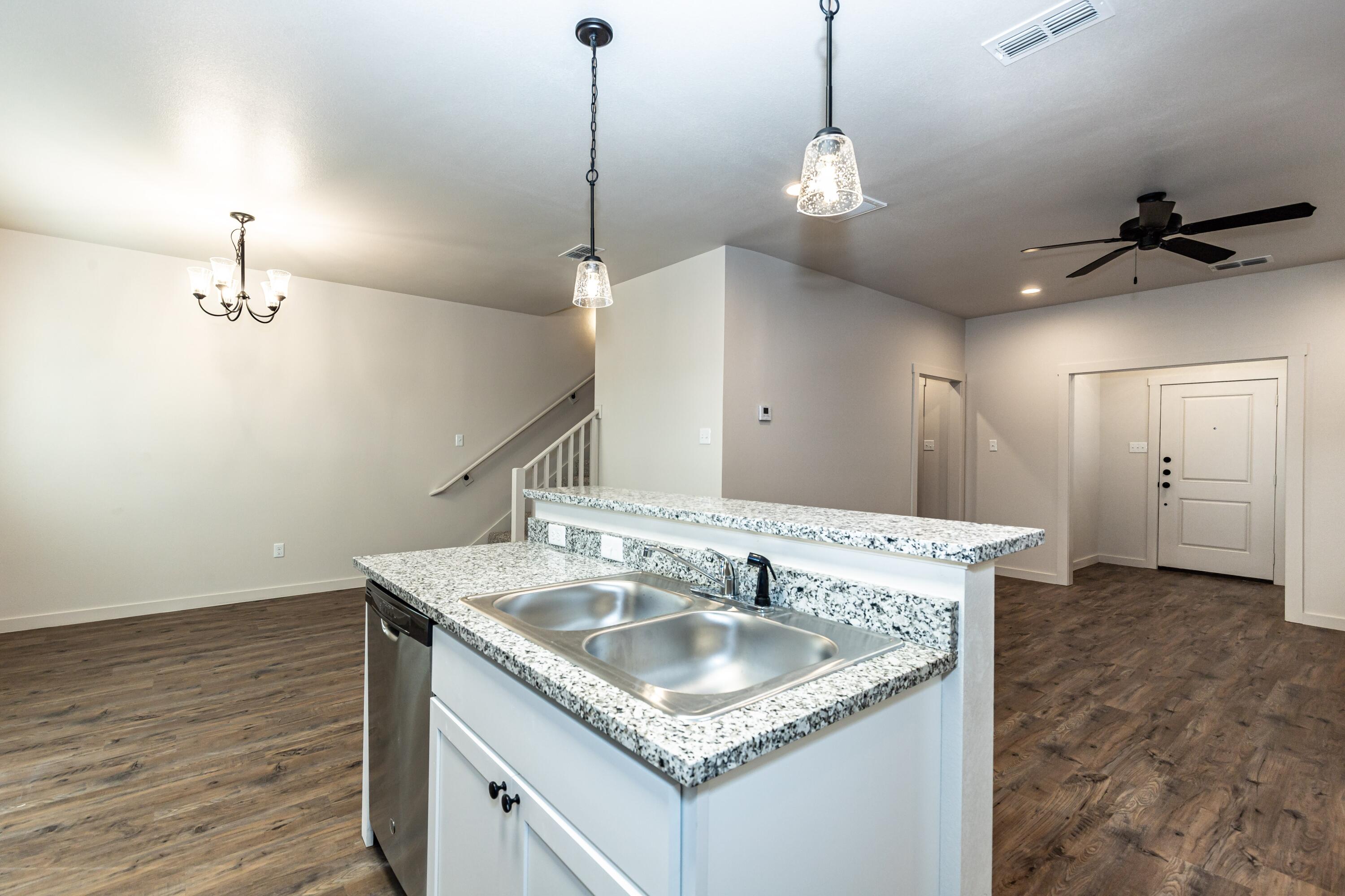 2529 138th Street Lubbock, TX 79423 - Photo 10 of 24 a kitchen with a sink a counter space and a sink