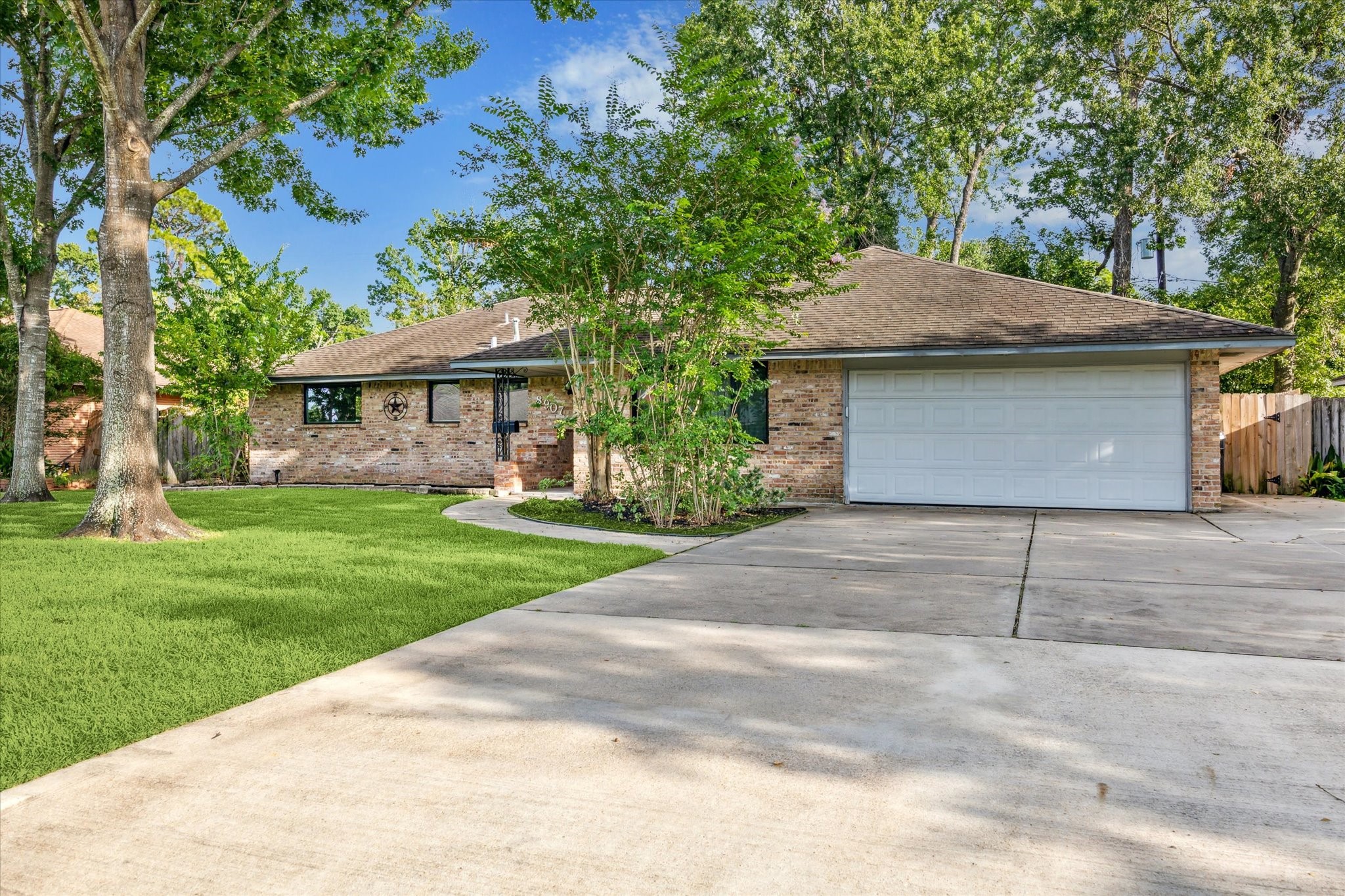 8907 Autauga Street Houston, TX 77080 - Photo 1 of 20 Welcome to 8907 Autauga St! This beautiful home is surrounded by mature trees, and it offers a serene, suburban feel. The driveway provides ample parking space.