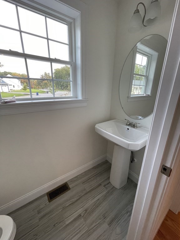 12 Hayfield Road, Unit 1 Dracut, MA 01826 - Photo 11 of 32 a bathroom with a sink and a toilet