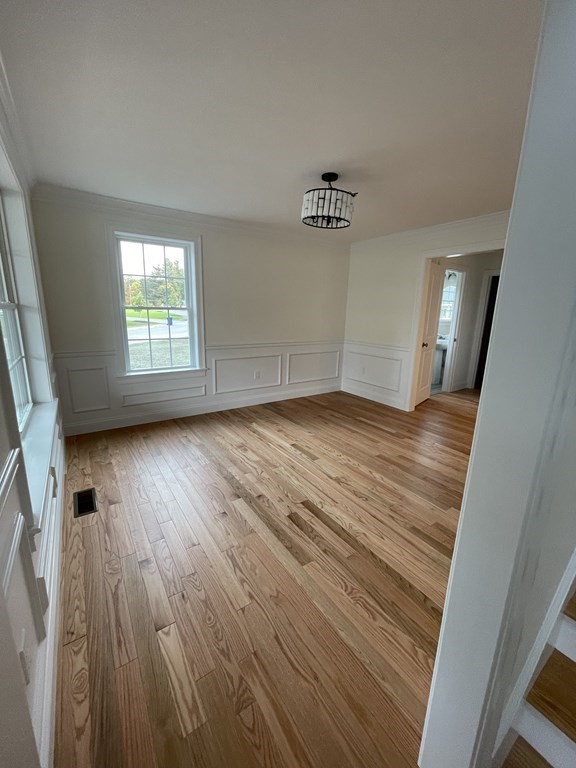 12 Hayfield Road, Unit 1 Dracut, MA 01826 - Photo 13 of 32 an empty room with wooden floor and windows