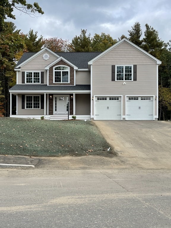 12 Hayfield Road, Unit 1 Dracut, MA 01826 - Photo 2 of 32 a front view of a house with a yard
