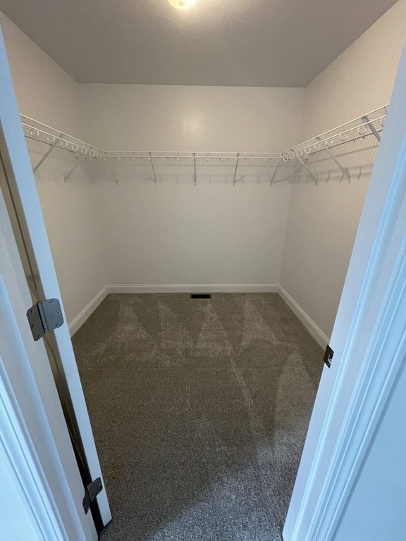12 Hayfield Road, Unit 1 Dracut, MA 01826 - Photo 23 of 32 a view of a room with racks on the wall