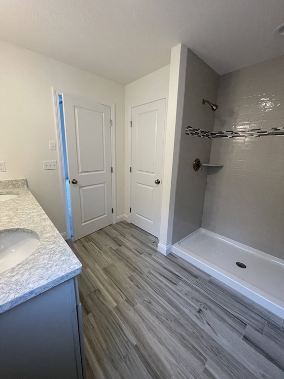 12 Hayfield Road, Unit 1 Dracut, MA 01826 - Photo 26 of 32 a bathroom with a granite countertop sink and shower