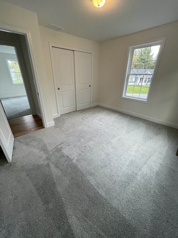 12 Hayfield Road, Unit 1 Dracut, MA 01826 - Photo 29 of 32 a view of an empty room and a window
