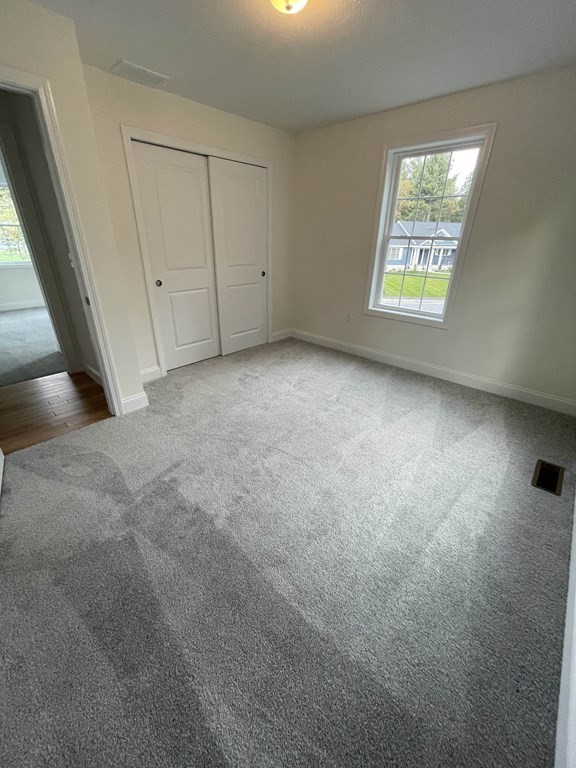 12 Hayfield Road, Unit 1 Dracut, MA 01826 - Photo 30 of 32 an empty room with windows