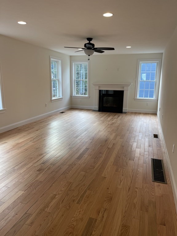 12 Hayfield Road, Unit 1 Dracut, MA 01826 - Photo 4 of 32 an empty room with wooden floor and windows