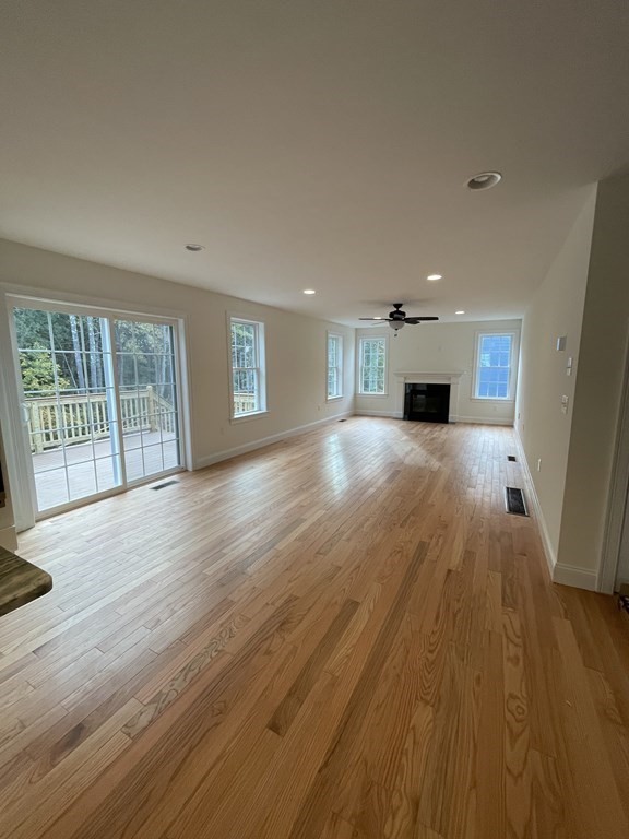 12 Hayfield Road, Unit 1 Dracut, MA 01826 - Photo 7 of 32 a view of an empty room with wooden floor and a window