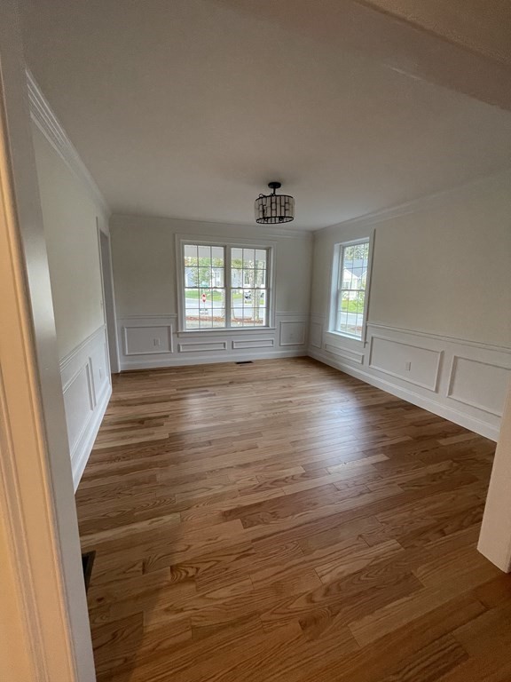 12 Hayfield Road, Unit 1 Dracut, MA 01826 - Photo 9 of 32 an empty room with wooden floor and windows