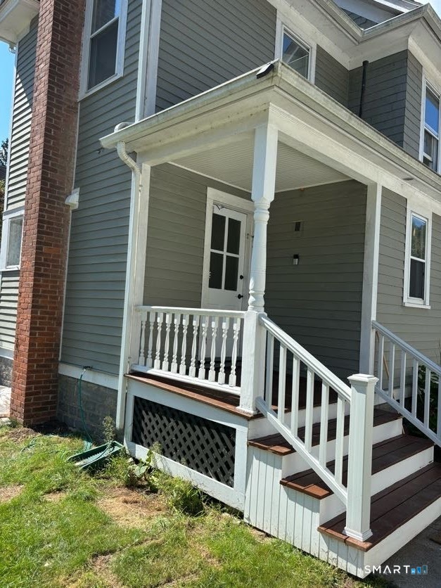 a view of a house with wooden deck and a yard