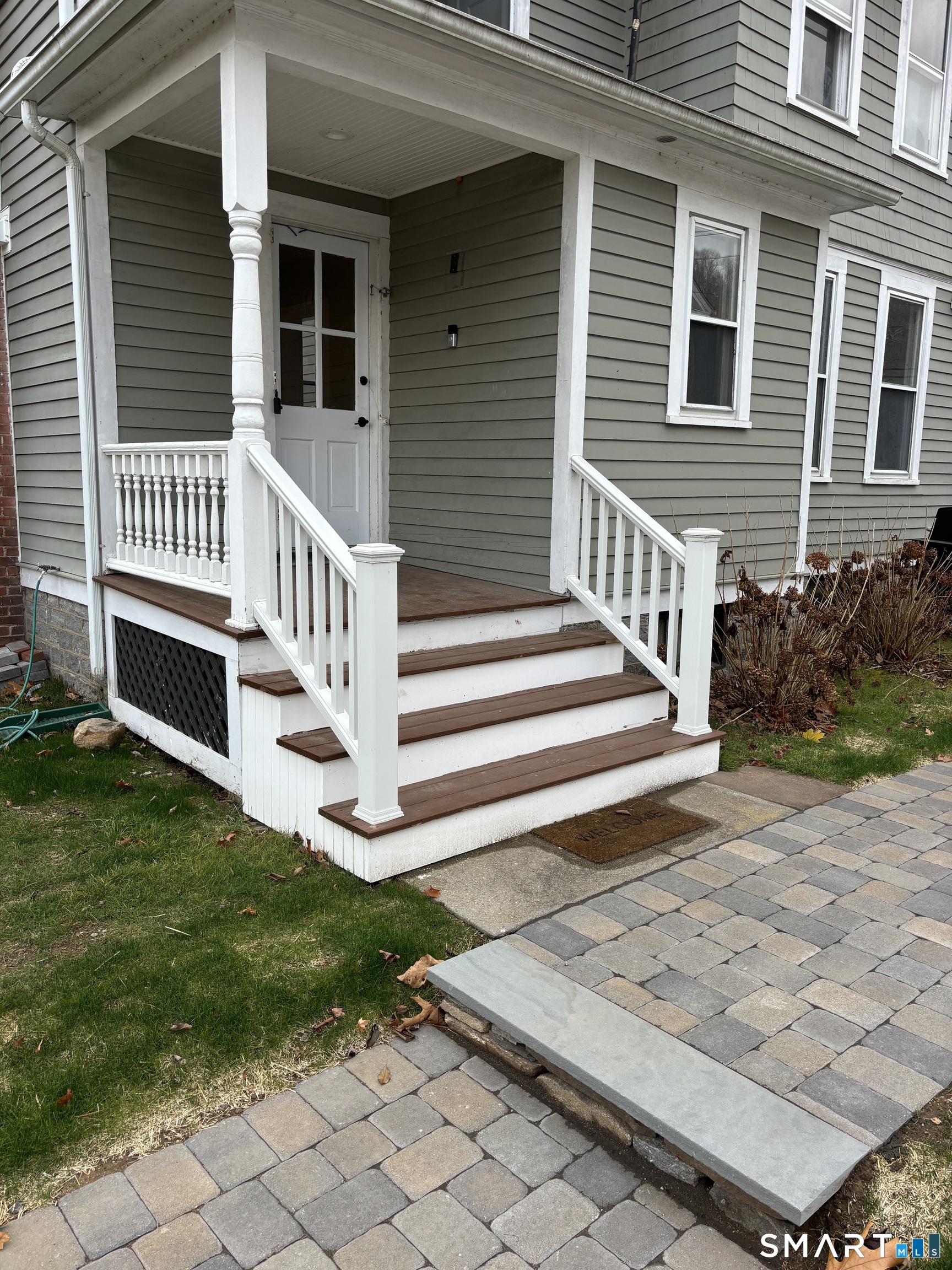 61 Main Street, Unit B Deep River, CT 06417 - Photo 13 of 13 a view of a house with a small yard and wooden fence