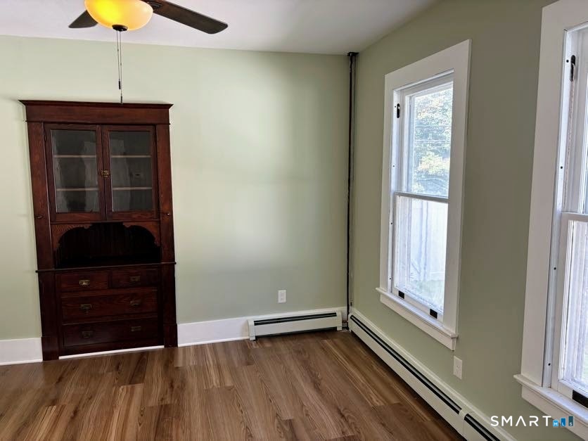 61 Main Street, Unit B Deep River, CT 06417 - Photo 4 of 13 a view of an empty room with wooden floor and a window