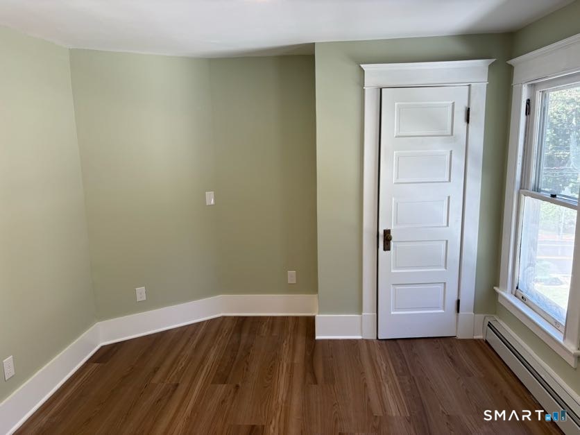 61 Main Street, Unit B Deep River, CT 06417 - Photo 9 of 13 an empty room with wooden floor and windows