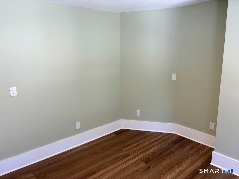 61 Main Street, Unit B Deep River, CT 06417 - Photo 10 of 13 a view of an empty room with wooden floor